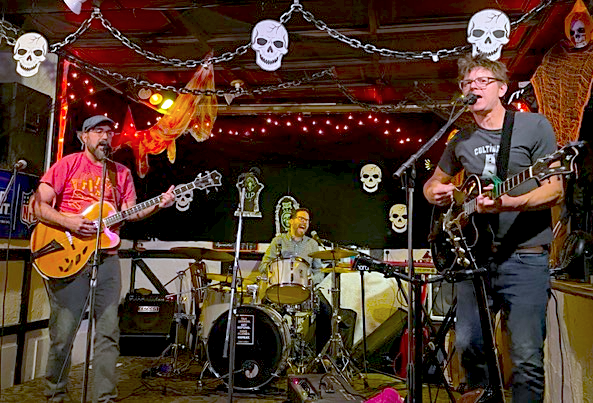 Hollow Body performs live on the stage at The Toucan in Kingston amidst Halloween-themed decorations, in 2025.